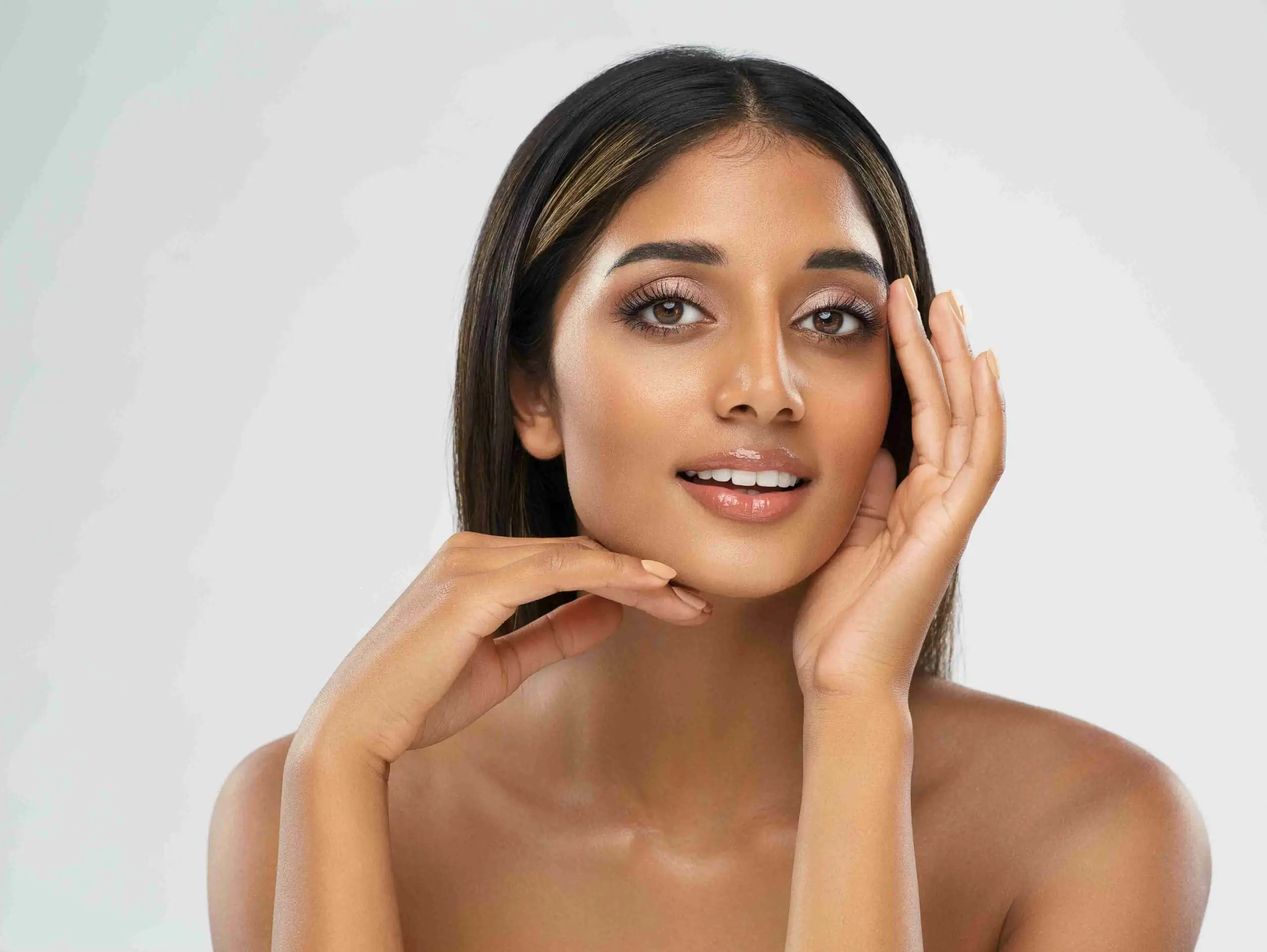 a woman with her hands on her face | Allure Dermatology | Edinburg, TX